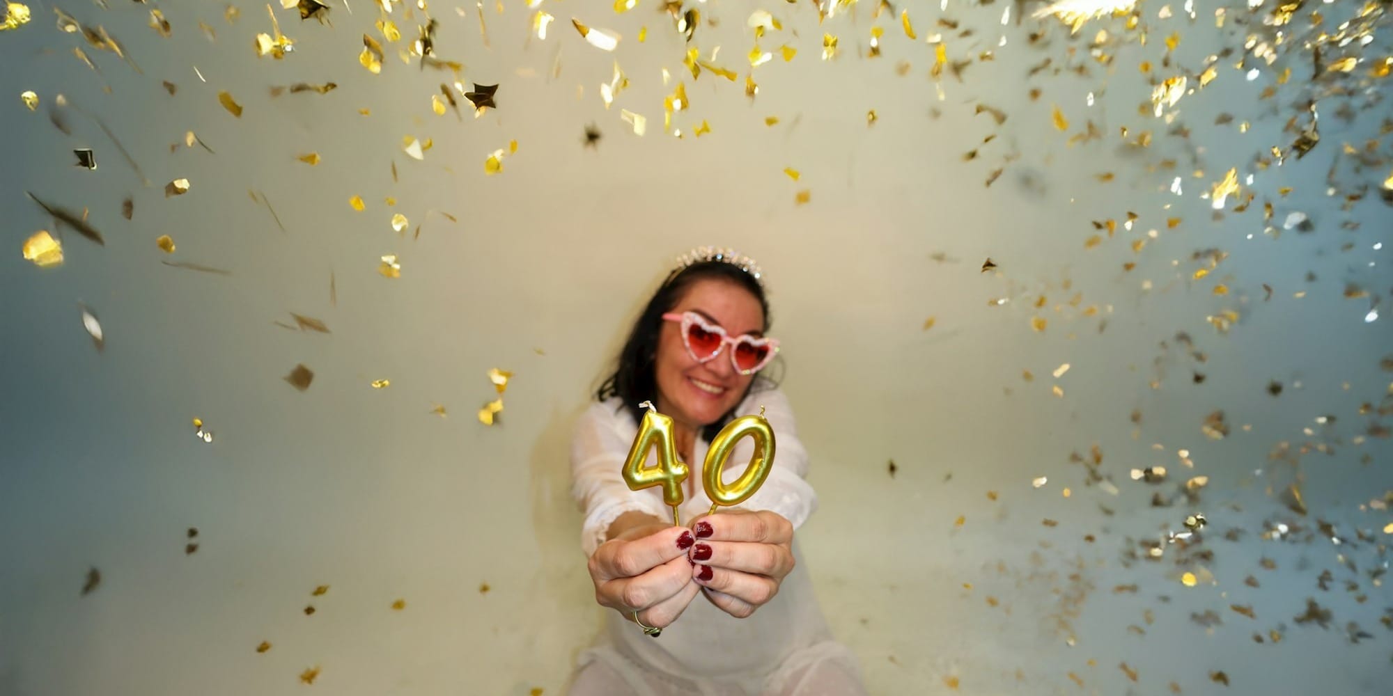 Woman celebrating 40th birthday with confetti